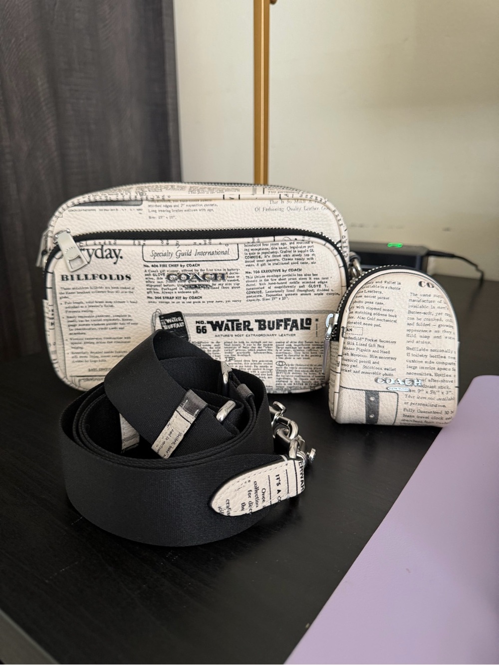 Coach Finlay in newspaper print with crossbody strap